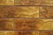 Macro of brick-like brown embossed ceramic tiles siding