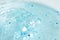Macro bubble blue shower gel with scrub grain with selective focus. Concept laboratory tests and research