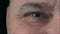 Macro close-up aged manâ€™s brown eyes.  Human eye, eyelash, eyelid, brown iris, face. Man eyes looking surprised amazed emotion