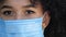 Macro close up beautiful american woman with blue protective mask on face from coronavirus covid outbreak second wave of