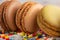 Macro, close-up of colored french macaroons, sweets with colored caramel sweets