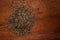 Macro close-up of Organic Black Cumin Elwendia persica or black caraway or Kala jeera on wooden top background.