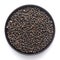 Macro Close-up of Organic Black Gram Vigna mungo or whole black urad on a ceramic black bowl.