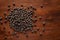 Macro Close-up of Organic Black Gram Vigna mungo or whole black urad cleaned on wooden top background