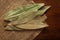 Macro close-up of Organic Indian bay leaf Cinnamomum tamala  Tez Patta on the wooden top background and jute mat.