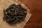 Macro close-up of Organic Indian long pepper  Piper retrofractum  on the wooden top background and jute mat.