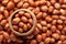 Macro Close-up of organic red-brown peanuts Arachis hypogaea  in an earthen clay pot kulhar on the self background.