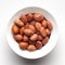 Macro Close up of organic red brown peanuts Arachis hypogaea inside a white Ceramic bowl,