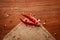 Macro close-up of Organic two red chili pepper Capsicum annuum  on the wooden top background and jute mat.