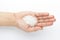 Macro Close up of organic white sago or sabudana small size on the palm of a Female hand.
