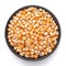 Macro Close up organic yellow corn seed or maize Zea mays inside a black ceramic bowl.