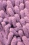 Macro close up of pink chenille microfiber texture for cleaning, trapping dust