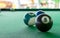 Macro close up shot of a eight ball billiard with some blurry billiard ball in the background