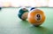 Macro close up shot of a nine ball billiard with some blurry billiard ball in the background