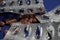 Macro close up of silver empty blisters with pile of capsules, blue background - medicines waste abuse concept