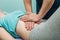 Macro close up of therapist applying pressure on stomach detail of hands massaging female belly.