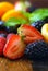 Macro closeup of mixed summer fruit on wooden table.