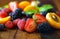 Macro closeup of mixed summer fruit on wooden table.
