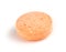 Macro closeup of orange vitamin c chewable tablet isolated