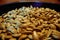 Macro closeup pumpkin seeds on black dish brown skin