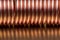 Macro of copper coil on metallic surface