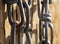 Macro Detail of Chains Hanging Next to Wooden Background