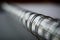 Macro detail of a metal binding spiral of the white notepad on the silver surface