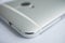 Macro detail of a silver brushed aluminum texture of sleek modern smart phone with shiny beveled edges