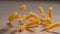 MACRO, DOF: Cinematic shot of dry pasta bouncing around the dining room table.