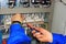 Macro electrician`s hands with screwdriver connect wires on background of electrical cabinet