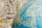 Macro focus on the globe on the background of cash