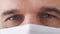 Macro footage of eyes of tired doctor wearing medical mask