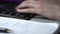 Macro footage of woman hands with manicure working at office and typing on keyboard
