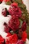 Macro on frozen red roses. Funeral arrangement covered in snow