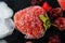 Macro frozen strawberries, raspberry, blackberry, pieces of ice on a black shale board, frozen fruit, set