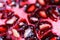 Macro full frame close up of red shiny juicy pomegranate fruit seeds focus on seeds lower third