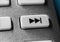 Macro Of A Grey Skip Forward Button On Chrome Remote Control For A Hifi Stereo Audio System