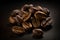 A macro illustration of a pile of fine selected roasted coffee beans on black background