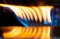 A Macro Image of a Blurry Blue and Yellow Flames on Gas Stove Burner