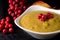 Macro Image of Delicious Squash Thanksgiving Soup Decorated with Rowan Berries and Cream