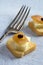 Macro Image of Mini Toast with Cheese, Caramelized Apple, Raisin and Antique Fork