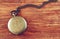 Macro image of old vintage pocket watch on wooden table. top view