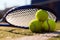 Macro image of three tennis balls and racket