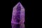 Macro mineral stone Amethyst crystal on a black background