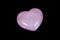 Macro mineral stone Heart pink quartz on a black background