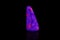 Macro mineral stone ruby under ultraviolet light on a black background