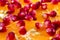 Macro peeled ripe pomegranate fruit with many slices of orange f