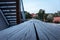 Macro perspective view of wood railing on building outdoors.