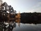 Macro photo with a beautiful background of autumn landscape with the prospect of lake water and trees with Golden foliage