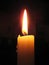 Macro photo with decorative background of a burning candle in the dark atmosphere of the cafe for decoration and design